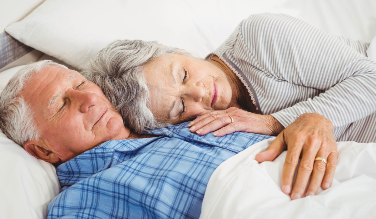 elderly couple resting on bed